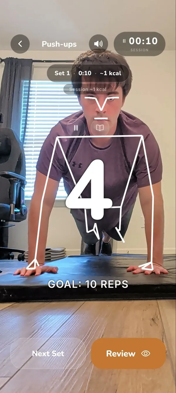 Hughie counting push-ups live: pose landmarks tracked on the body with the rep count at 4 of a 10-rep goal
